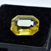Natural yellow sapphire, 7.70 carats, a certified emerald-shaped loose gemstone.
